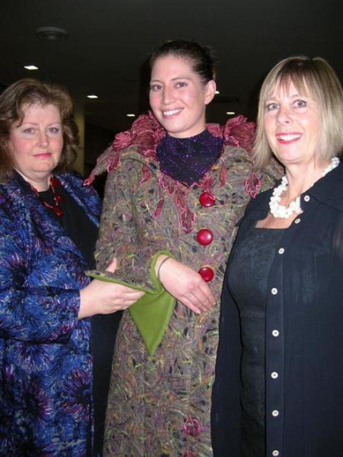 Winning WoolOn garment creator Donna Hansen (left), helps fit the creation "Wolf With The Red...