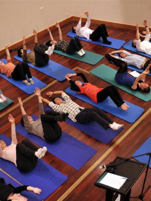 Back in Motion pilates instructor Laura Dawson leads a Pilates class in the Glenroy Auditorium in...