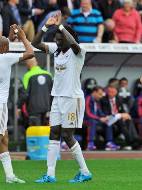 Bafetimbi Gomis celebrates with Andre Ayew after scoring the second goal for Swansea. Photo:...