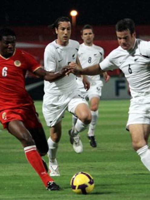 Bahrain's Jaycee John, left, fights for the ball with New Zealand's Ryan Nelsen,during their 2010...