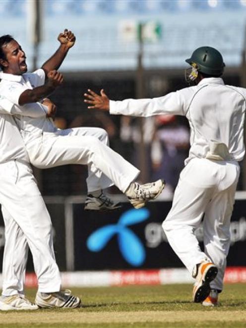 Bangladesh players, from left, Shahriar Nafees, Elias Sunny and Raqibul Hasan celebrate the...