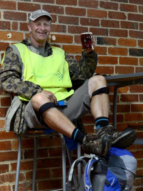 Barmy Army founding member and charity fundraiser Robin Moore enjoys a beer after completing a...