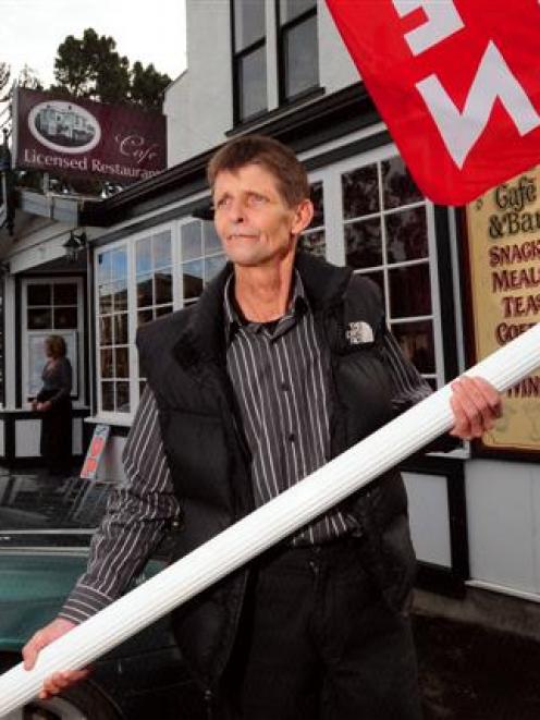 Barry Monahan with one of the new Dunedin City Council parking signs he removed from in front of...