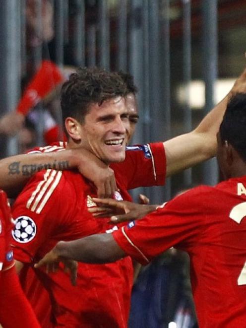 Bayern Munich's Mario Gomez (C) celebrates his goal against Real Madrid with teammates during...