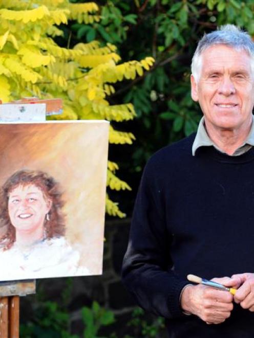 Bayfield High School principal Denis Slowley with a portrait he has painted of his late wife,...