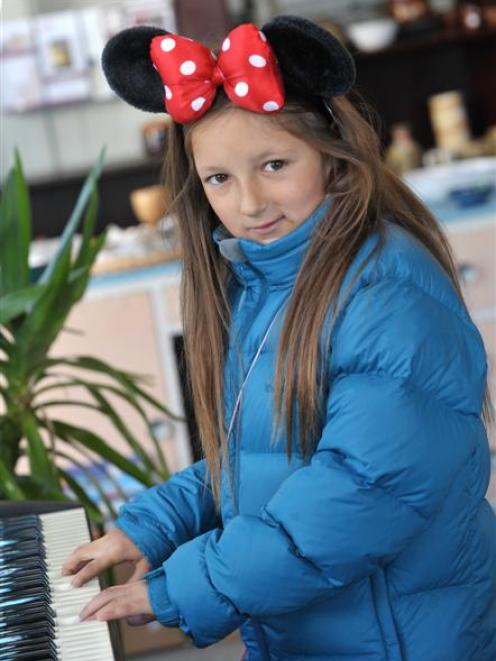 Bella Langley (10), of Dunedin, tries out a musical instrument at the hospice shop. Photo by...