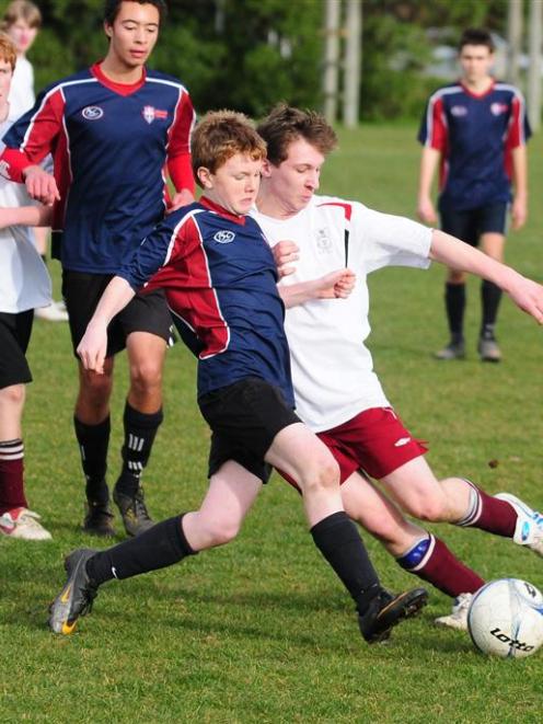 Ben O'Farrell (Kavanagh, left)  and Tim O'Neill (Logan Park High) battle it out for possession....