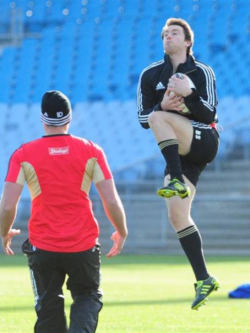 Ben Smith leaps high to catch the ball while Israel Dagg watches during an All Blacks training...