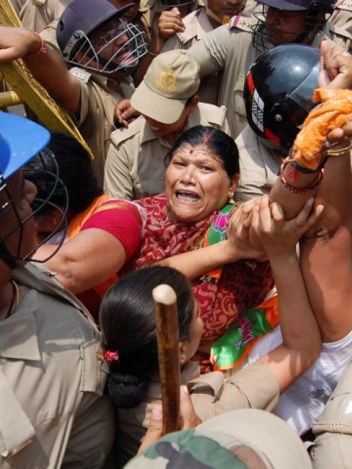 Bharatiya Janata Party supporters are stopped by police from moving towards the office of...