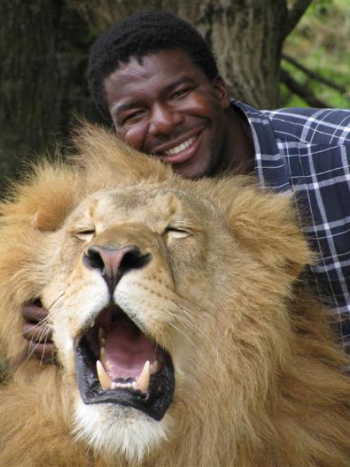 Big cat keeper Dalu Mncube with Abdullah, one of the Zion Wildlife Gardens' big cats. Photo by...