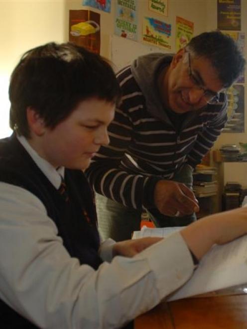 Big Picture Learning owner Rakesh Pandey (centre) tutors secondary pupil Harrison Skeggs (14)....