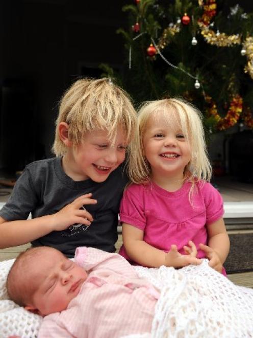 Big siblings Liam and Emily with newborn sister Olivia, who arrived yesterday. Photo by Stephen...