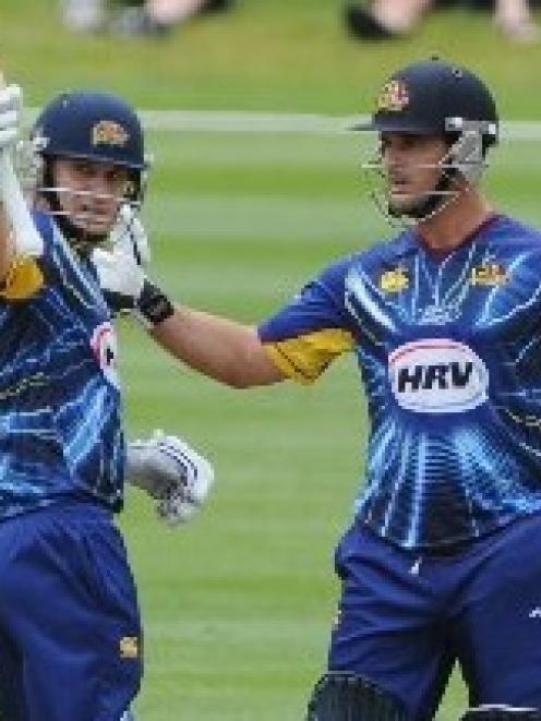 Black Caps and Otago all-rounder Nathan McCullum (left) is congratulated for reaching 50 by team...