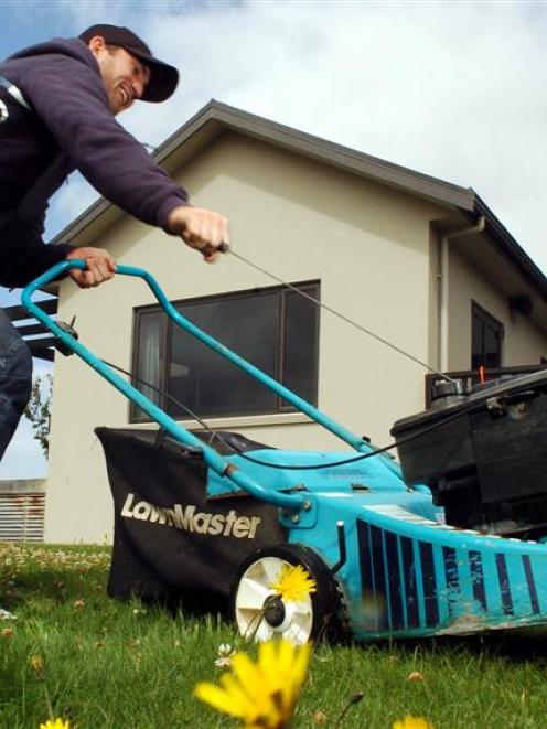 Black Caps and Otago batsman Neil Broom struggles to get his lawnmower started at his Fairfield...
