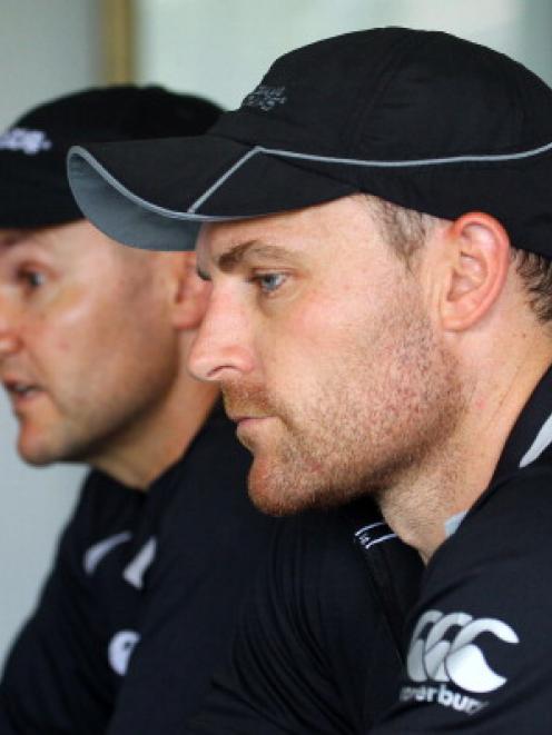 Black Caps captain Brendon McCullum (R) and coach Mike Hesson attend a press conference in Durban...