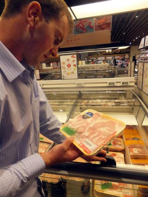Blair Smith checks product at a Mayfull retail store selling New Zealand beef in Taiwan. Photo...