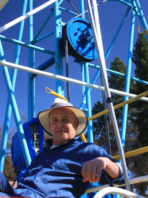 Blossom Festival event manager Martin McPherson, of Alexandra, sits on a ferris wheel in Pioneer...