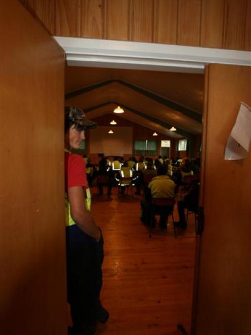 Blue Mountain Lumber employees wait in a small hall on the company’s premises before hearing that...