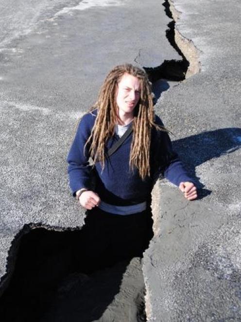 Bonham Lauder stands in a fissure in Avonside Dr, near his Christchurch home. Photo by Seth Gorrie.