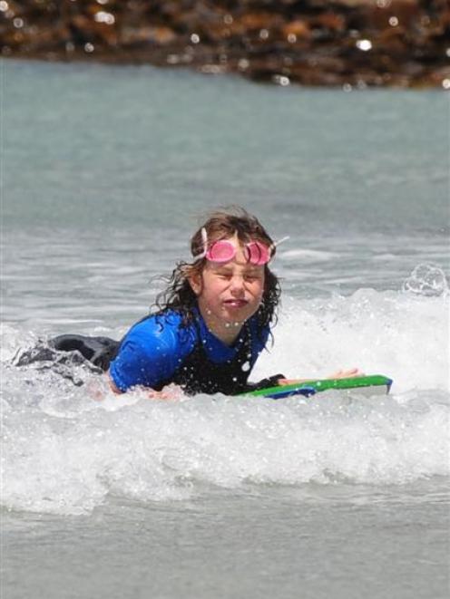 Boogie boarding close to shore at Brighton beach yesterday is Rebekah Pitcaithly (12). Photo by...