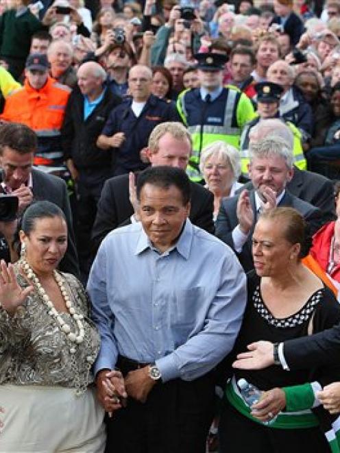 Boxing legend Muhammad Ali, centre, arrives in Ennis Ireland where a plaque was unveiled on...