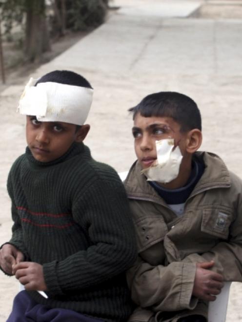 Boys wounded in a car bomb attack are seen after treatment at a primary school in Mussayab, about...