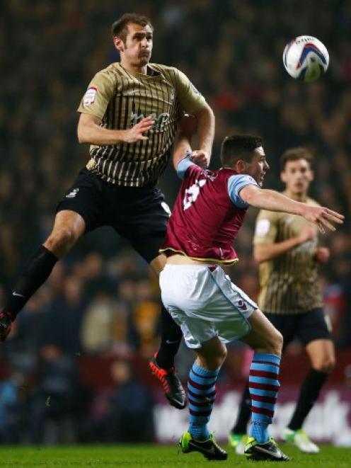 Bradford City's James Hanson (L) jumps above Aston Villa's Ciaran Clark during their English...