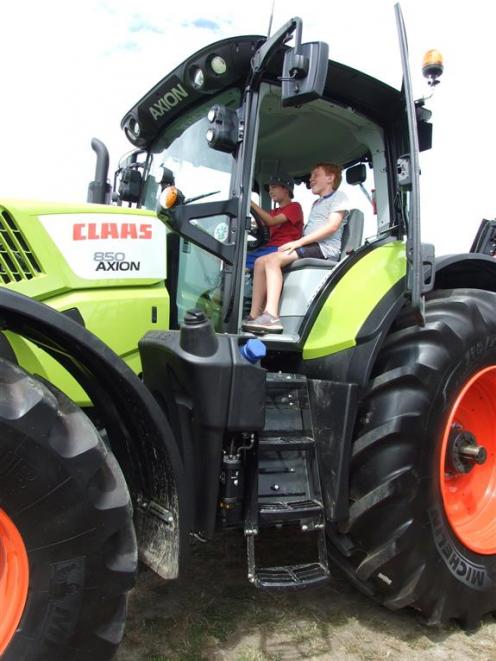 Bradley Shaw (left), who celebrated his 9th birthday yesterday, tests the driving seat of this...