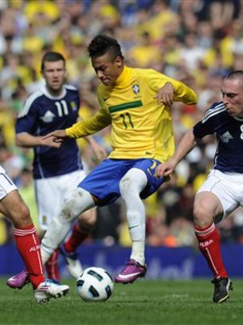 Brazil's Neymar, 2nd right, keeps the ball from Scotland's Scott Brown, right, and James Morrison...