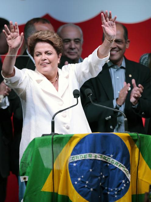 Brazil's President and Workers' Party (PT) presidential candidate Dilma Rousseff reacts during...