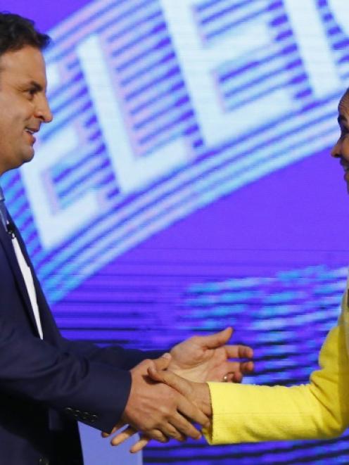 Brazil's presidential candidate Marina Silva (R) of Brazilian Socialist Party (PSB) greets Aecio...