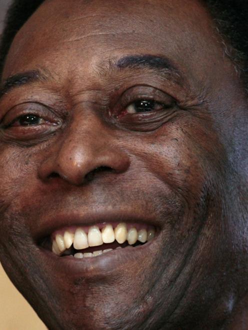 Brazilian soccer legend Pele smiles during a news conference in Hong Kong in this March 7, 2011...