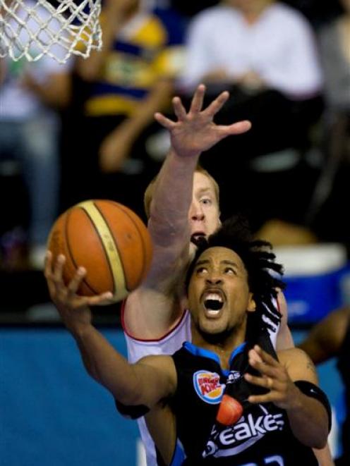 Breakers player CJ Bruton in action against Adam Ballinger of the Adelaide 36ers during the ANBL...