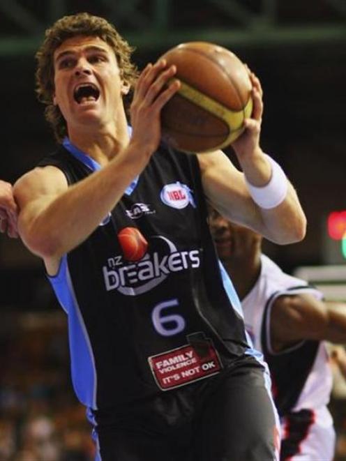 Breakers shooting guard Kirk Penney (above left) drives to the basket during the round seven NBL...