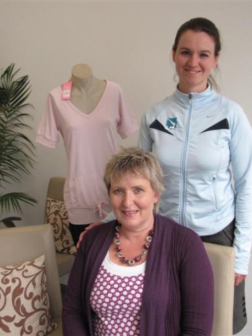 Breast cancer survivor Jo Grimmer, seated, with The Studio Pink Pilates Trust pilates instructor...