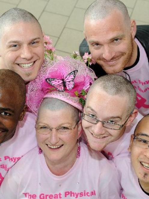 Breast-cancer survivor Sandy Wilson (centre) flanked by head-shave volunteers (clockwise, from...