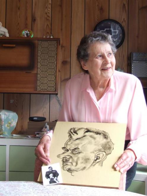 Brenda Taylor with a sketch of her father and a photograph of the pair together. Photo by Matthew...