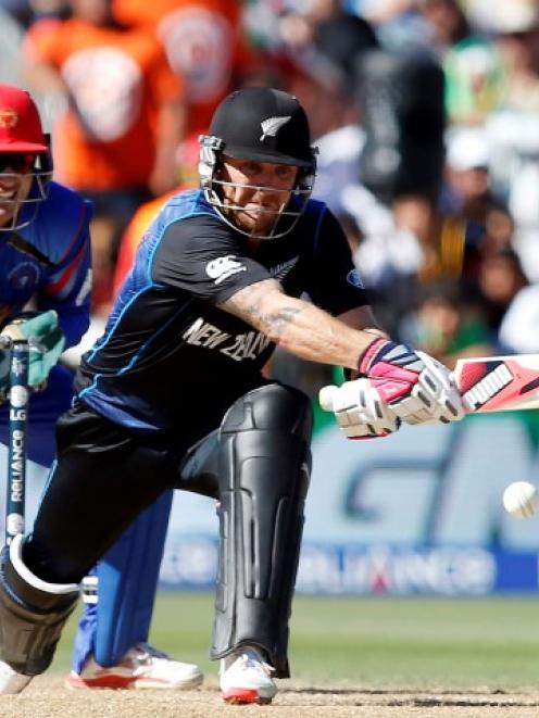 Brendon McCullum plays a reverse sweep shot watched by Afghanistan's Afsar Zazai during their...