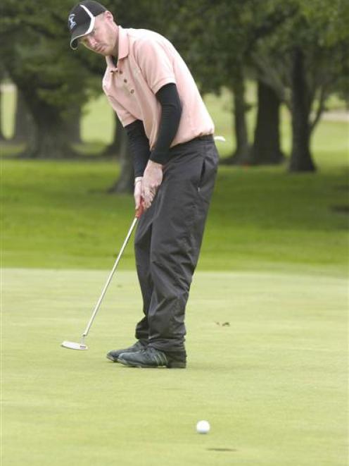 Brent McEwan, of the St Clair club, sinks a putt on his way to winning the Otago strokeplay...