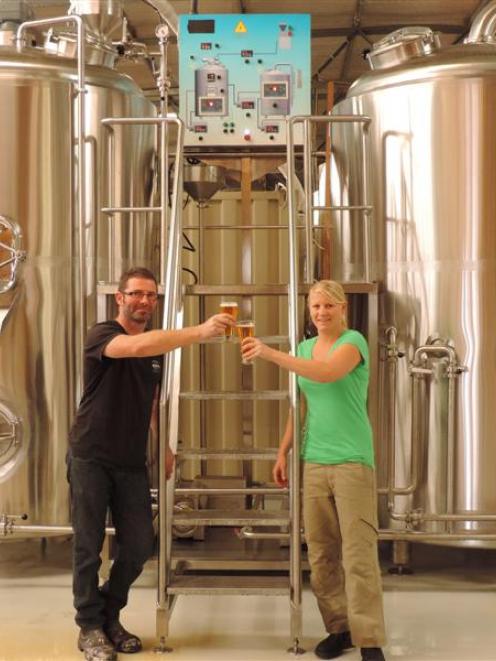 Brewers Phillip Scott and Jess Wolfgang  test one of their beers. Photo by David de Lorean.