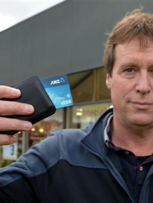 Brian McKay, of Dunedin, holds the Visa payWave credit card with which he  unintentionally paid...