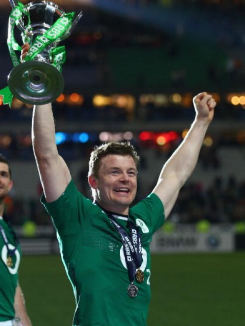 Brian O'Driscoll celebrate with the trophy after Ireland won the Six Nations championship with a...