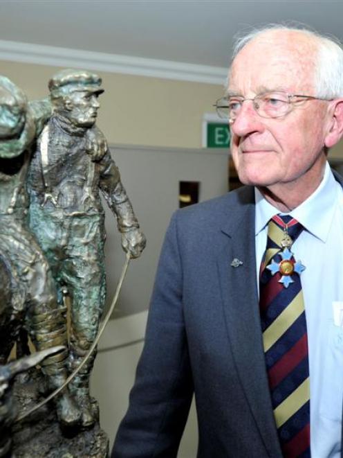 Brigadier Dr Brian McMahon and the Anzac of the Year bronze statuette. Photo by Gregor Richardson.