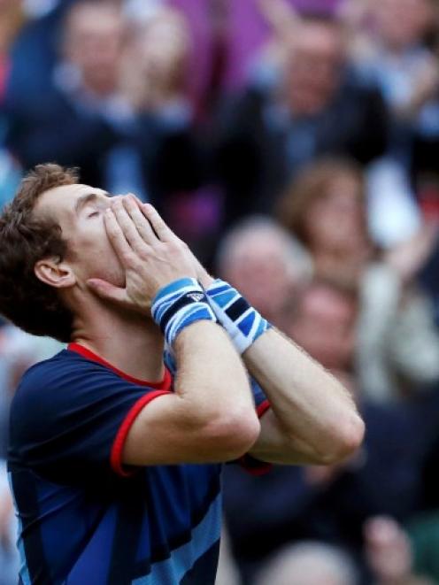 Britain's Andy Murray reacts after winning his men's singles semifinal match against Serbia's...
