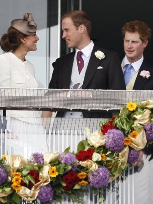 Britain's Duke and Duchess of Cambridge, left, and Prince Harry wait for the start of the Derby...