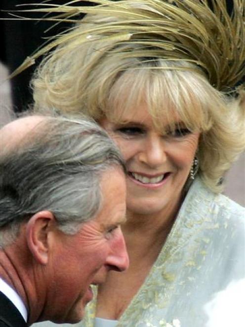 Britain's Prince Charles (L) and the Duchess of Cornwall greet well-wishers at Windsor Castle...