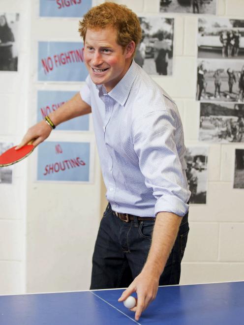 Britain's Prince Harry plays table tennis with students during his visit to the TYLA (Turn Your...
