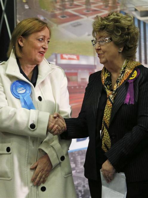 Britain's ruling Conservative Party candidate Christine Emmett (left) congratulates UKIP...