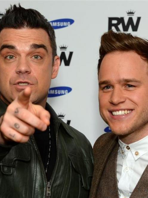 British musicians Robbie Williams and Olly Murs who will support Williams on his 2013 European...