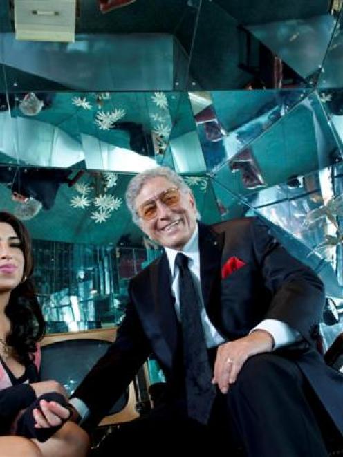 British singer Amy Winehouse and US singer Tony Bennett pose for a picture during the Body and...